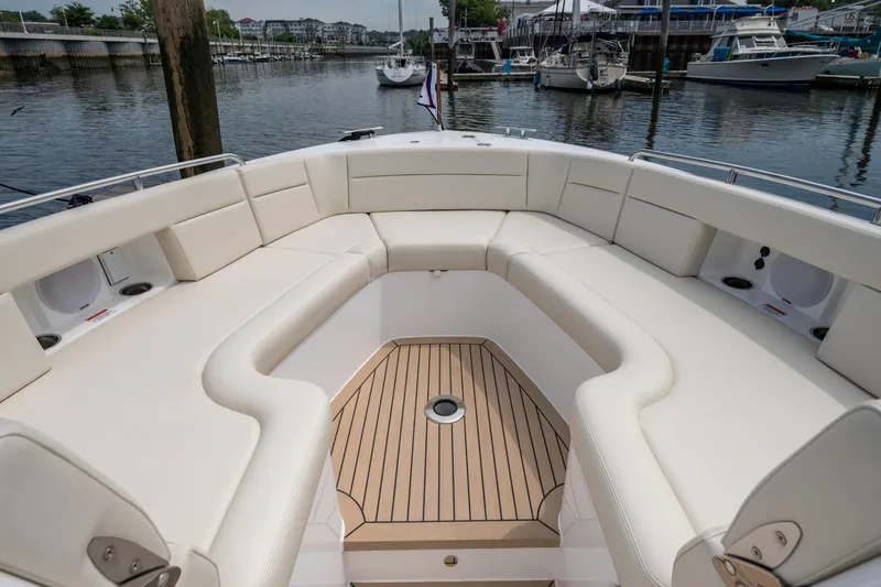 Slide: The Image of Luxurious seating area on 2025 MJM 3 boat, docked at a marina. - 26