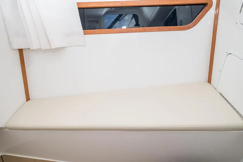 Slide: The Image of Interior of 2025 MJM 3 boat with cushioned seating and window. - 28