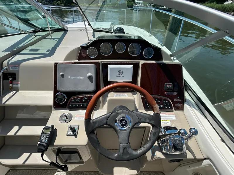 Slide: The Image of 2008 Sea Ray 330 Sundancer helm with Raymarine navigation, steering wheel, and control panel. - 10