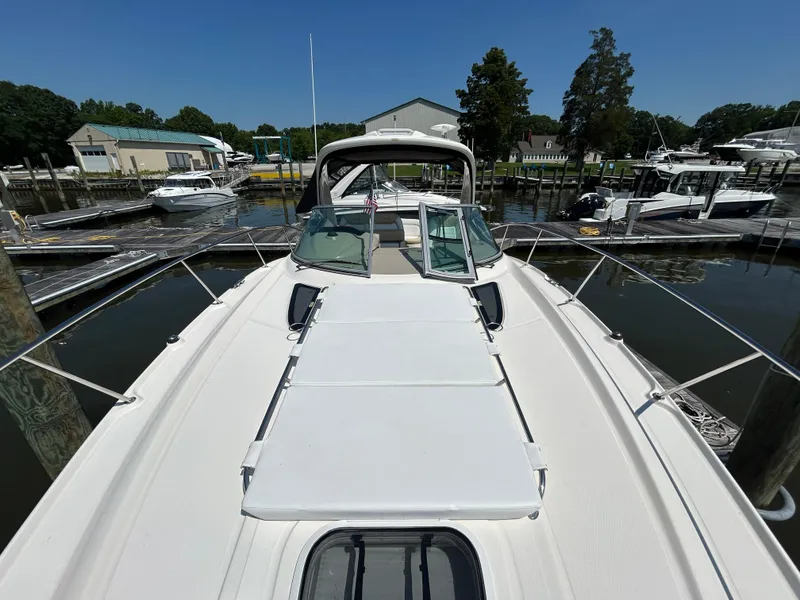 Slide: The Image of 2008 Sea Ray 330 Sundancer docked at marina, featuring spacious deck and sleek design. - 15