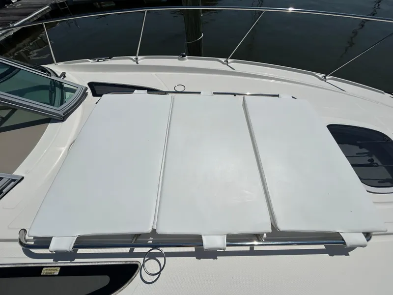 Slide: The Image of 2008 Sea Ray 330 Sundancer boat deck with sunpad, docked at marina. - 16