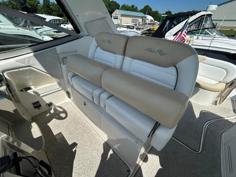 Slide: The Image of 2008 Sea Ray 330 Sundancer interior with beige and white seating, docked at marina. - 17