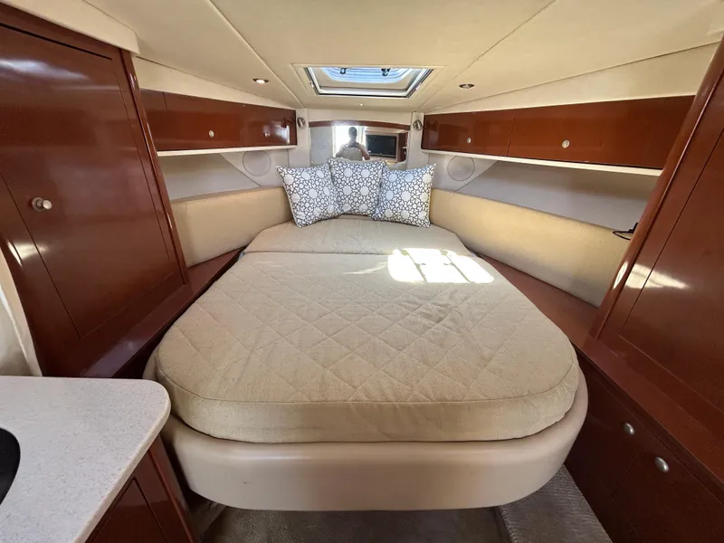 Slide: The Image of Luxurious cabin interior of 2008 Sea Ray 330 Sundancer yacht with cozy bed and wooden cabinets. - 20