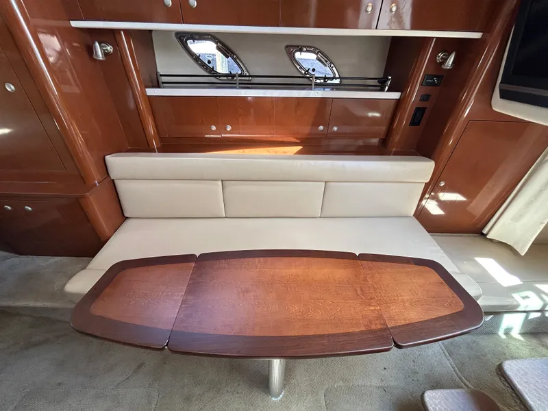Slide: The Image of Interior of 2008 Sea Ray 330 Sundancer with wooden table and beige seating. - 21
