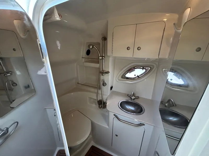 Slide: The Image of 2008 Sea Ray 330 Sundancer bathroom with sink, shower, and porthole window. - 30