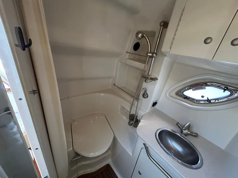 Slide: The Image of 2008 Sea Ray 330 Sundancer bathroom with toilet, sink, and showerhead. - 32