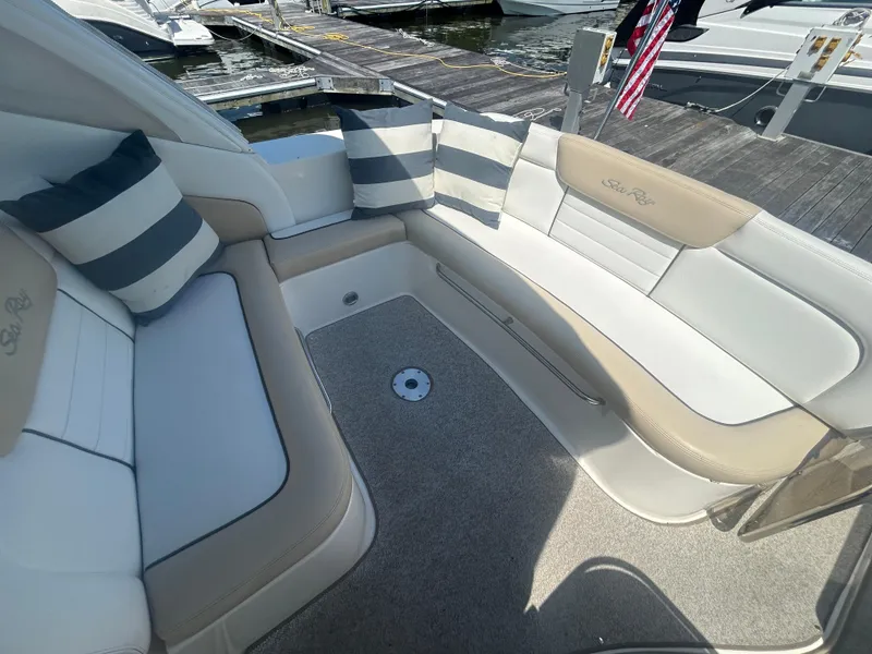 Slide: The Image of 2008 Sea Ray 330 Sundancer boat interior with striped cushions and dock view. - 5