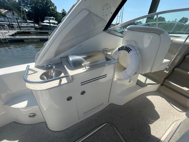 Slide: The Image of 2008 Sea Ray 330 Sundancer boat interior with sink, grill, and life preserver. - 7