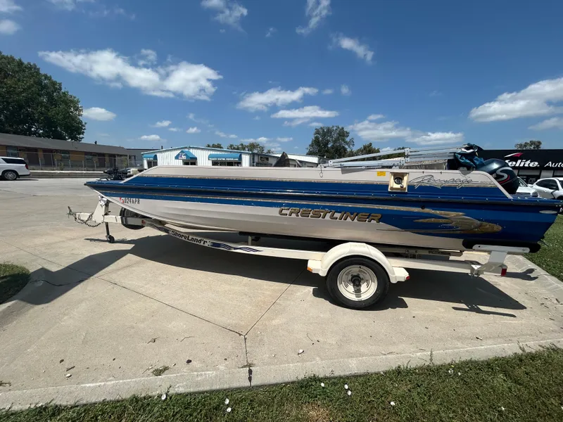 Slide: The Image of 1999 Crestliner Rampage 2000 boat on trailer under clear blue sky. - 0