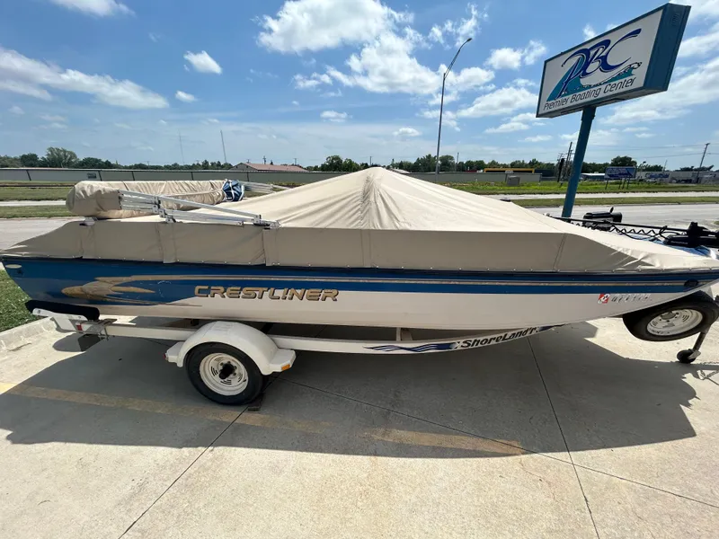 Slide: The Image of 1999 Crestliner Rampage 2000 boat with cover at Premier Boating Center. - 1
