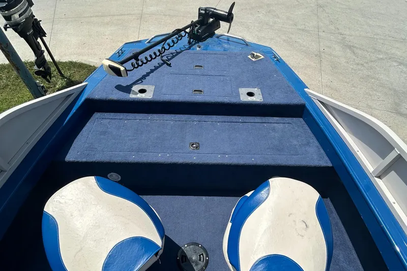Slide: The Image of 1999 Crestliner Rampage 2000 boat interior with blue carpet and white-blue seats. - 10