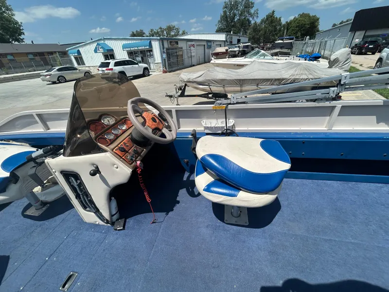 Slide: The Image of 1999 Crestliner Rampage 2000 boat interior with blue seating and control panel. - 6