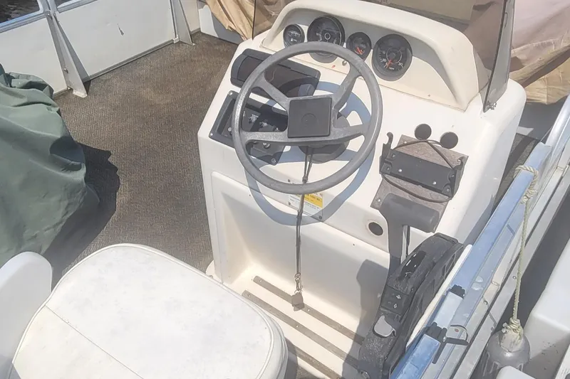Slide: The Image of 1997 Beachcomber Beach boat steering console with gauges and controls. - 4