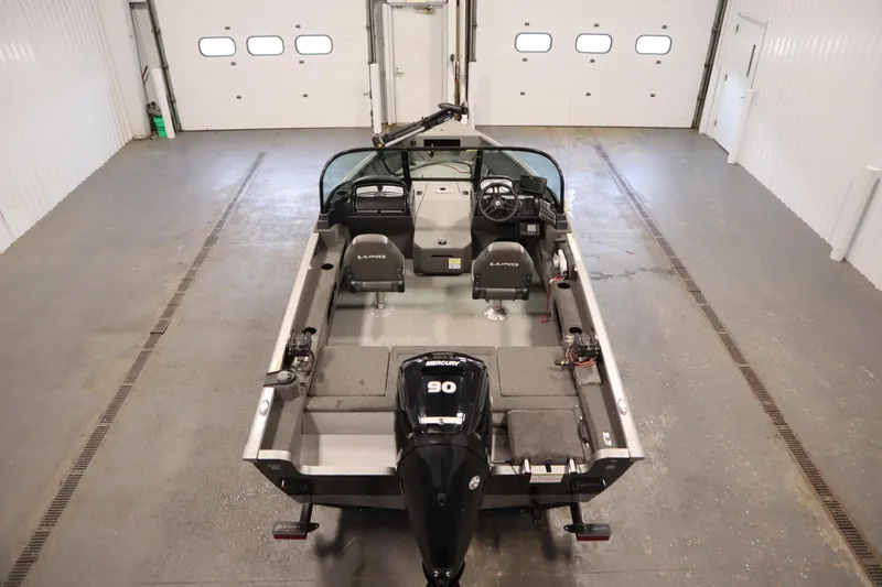 Slide: The Image of 2021 Lund 1675 ADVENTURE WT boat in a garage, featuring a Mercury 90 engine. - 10