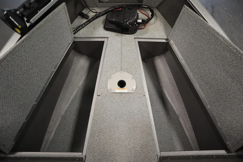 Slide: The Image of 2021 Lund 1675 ADVENTURE WT boat interior with storage compartments and carpeted flooring. - 18