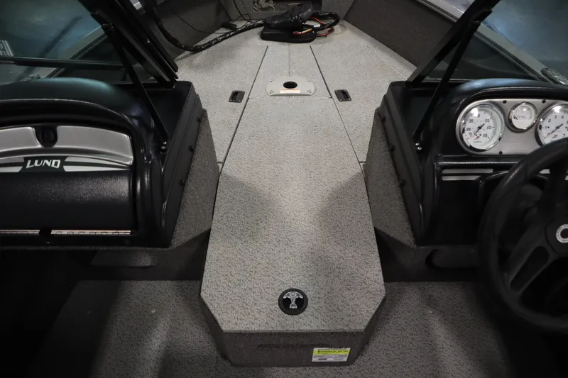 Slide: The Image of Interior of 2021 Lund 1675 ADVENTURE WT boat, featuring dashboard and seating area. - 19