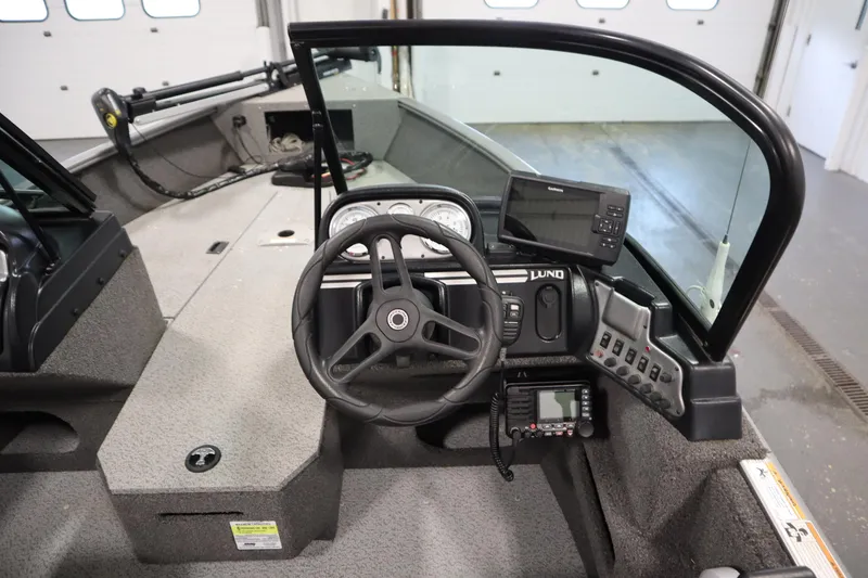 Slide: The Image of 2021 Lund 1675 Adventure WT boat dashboard with steering wheel and navigation equipment. - 22