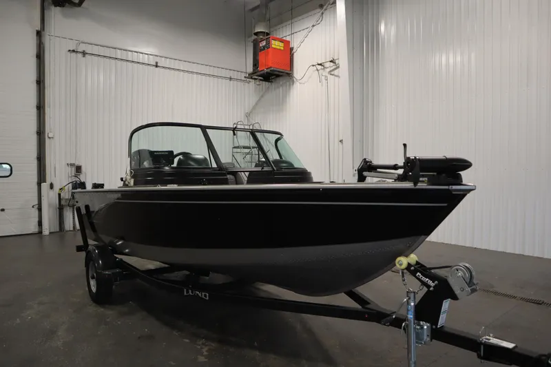 Slide: The Image of 2021 Lund 1675 ADVENTURE WT boat in indoor storage, black exterior, on trailer. - 3