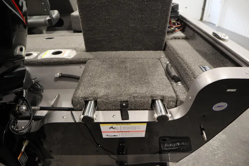 Slide: The Image of 2021 Lund 1675 ADVENTURE WT boat interior, featuring carpeted seating and storage area. - 45