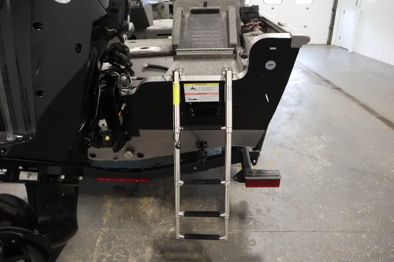 Slide: The Image of 2021 Lund 1675 ADVENTURE WT boat with rear ladder in a garage setting. - 46