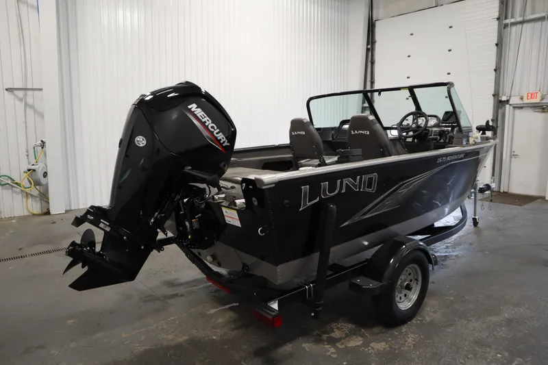 Slide: The Image of 2021 Lund 1675 Adventure WT boat with Mercury outboard motor in a garage setting. - 5