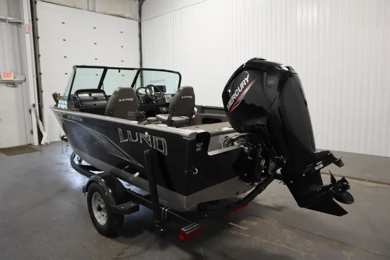 Slide: The Image of 2021 Lund 1675 ADVENTURE WT boat with Mercury outboard motor in a garage setting. - 7
