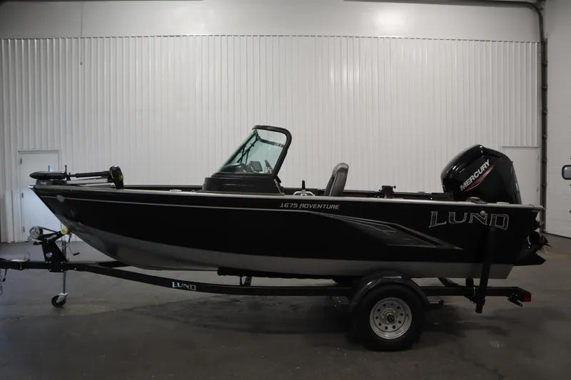 Slide: The Image of 2021 Lund 1675 Adventure WT boat with Mercury engine on trailer in indoor setting. - 8