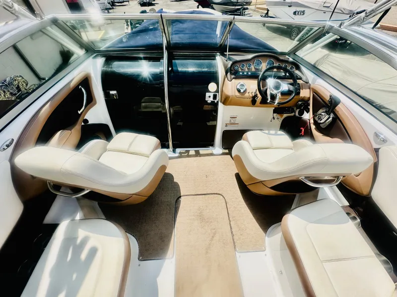 Slide: The Image of Interior of a 2012 Cobalt 243 boat with beige and brown seating. - 12
