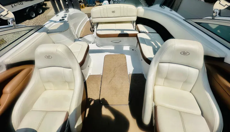 Slide: The Image of Interior of a 2012 Cobalt 243 boat with white and tan seating. - 13
