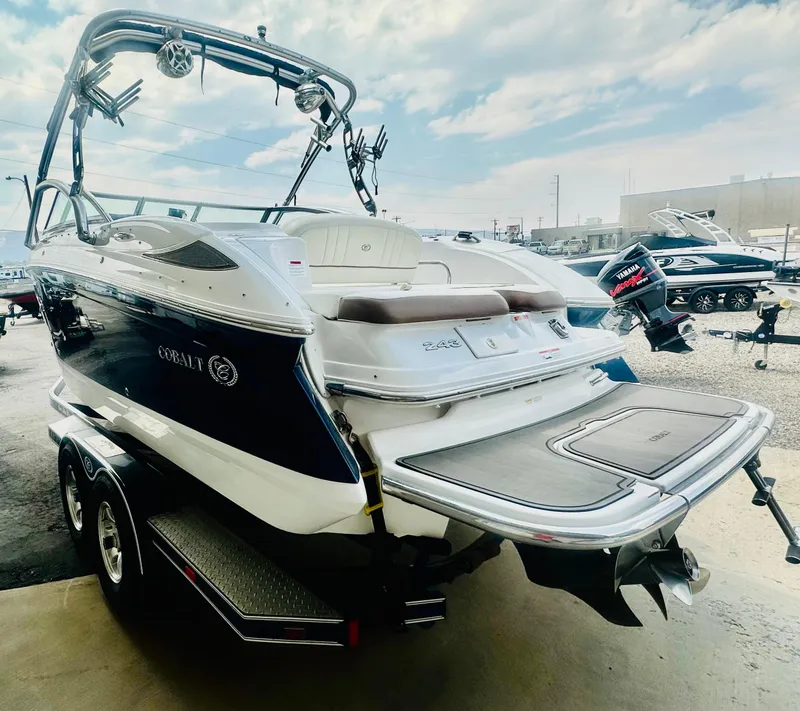 Slide: The Image of 2012 Cobalt 243 boat on trailer, featuring sleek design and spacious deck. - 5