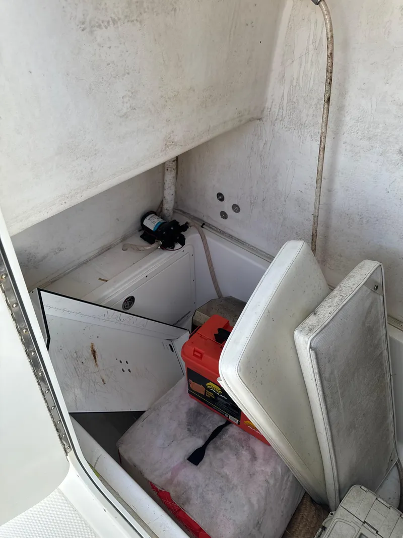 Slide: The Image of Interior of a 2015 Ocean Master 296 boat with storage compartment and equipment. - 10