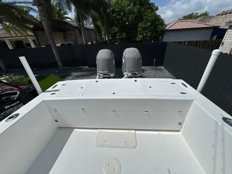 Slide: The Image of Ocean Master 296 boat deck with dual covered engines, 2015 model, in a tropical setting. - 3