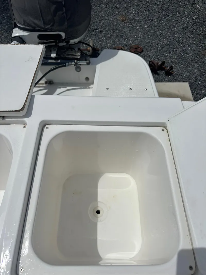 Slide: The Image of Open storage compartment on a 2015 Ocean Master 296 boat, with visible engine. - 4