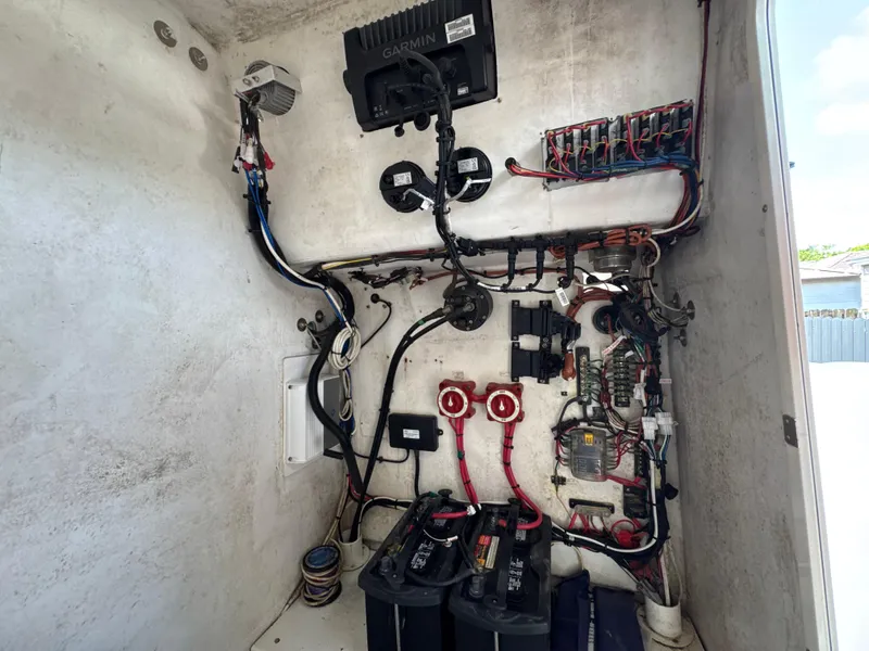 Slide: The Image of Electrical system inside a 2015 Ocean Master 296 boat, featuring wiring and battery setup. - 8