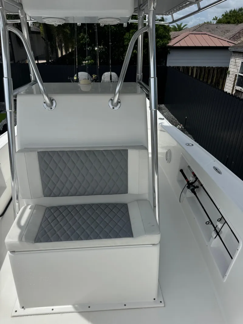 Slide: The Image of 2015 Ocean Master 296 boat interior with cushioned seating and rod holders. - 9