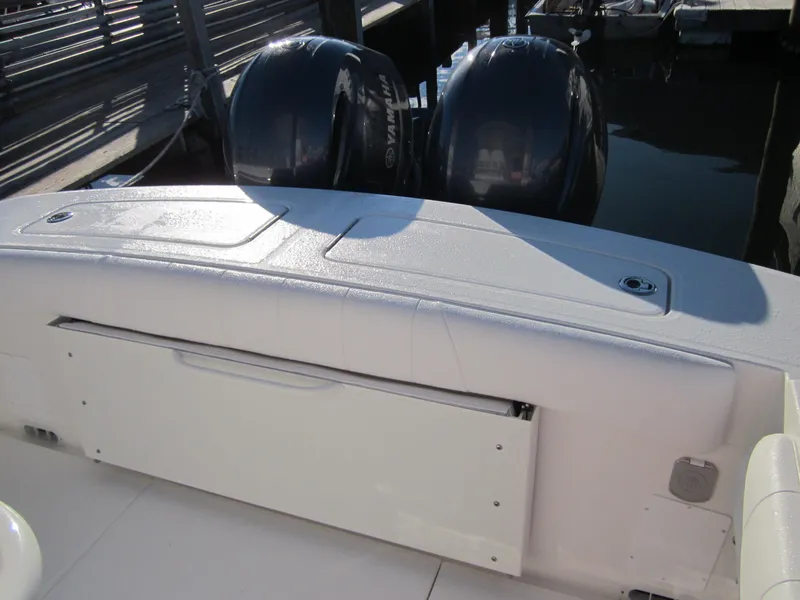 Slide: The Image of 2015 Regulator 25FS Center Console boat with dual outboard engines. - 14
