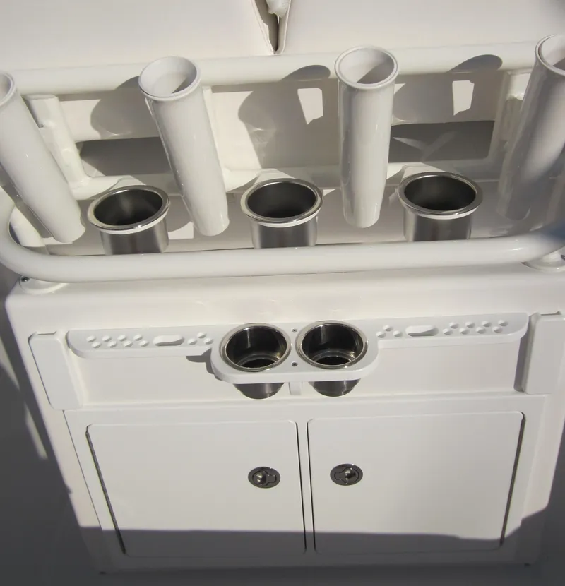 Slide: The Image of 2015 Regulator 25FS Center Console fishing rod holders and storage compartments. - 16