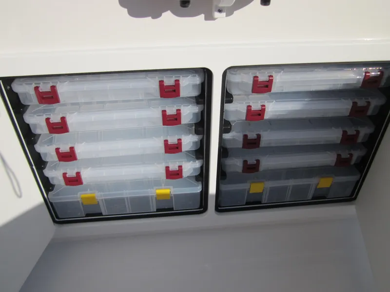Slide: The Image of Storage compartments with tackle boxes on a 2015 Regulator 25FS Center Console boat. - 17