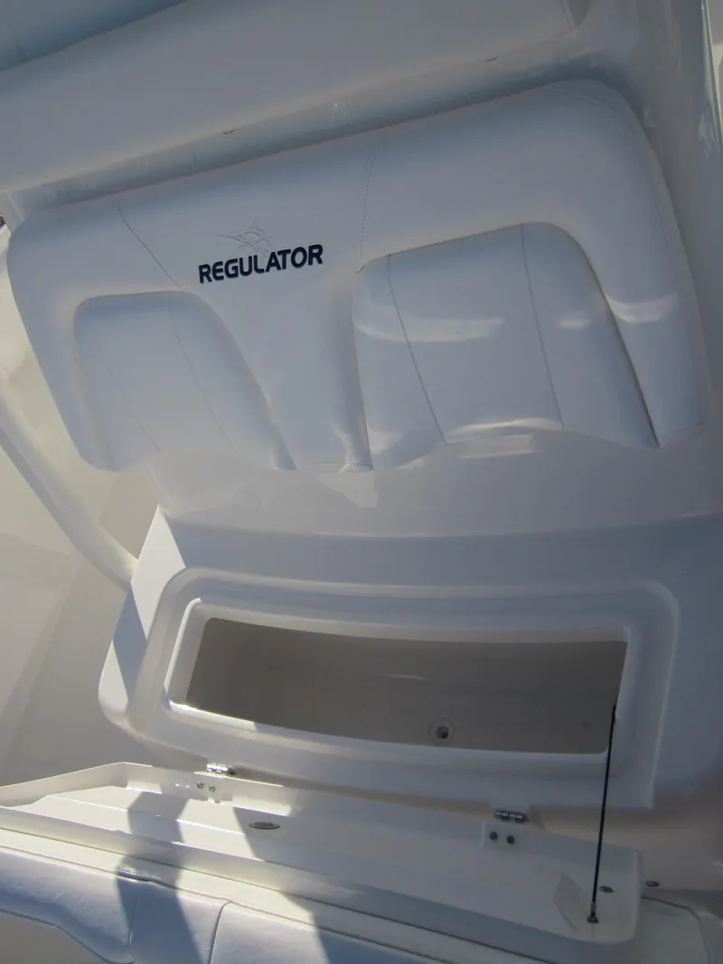 Slide: The Image of 2015 Regulator 25FS Center Console boat storage compartment open. - 20