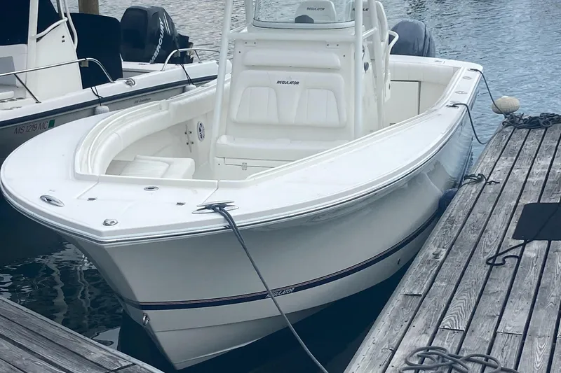 Slide: The Image of 2015 Regulator 25FS Center Console boat docked at marina. - 3