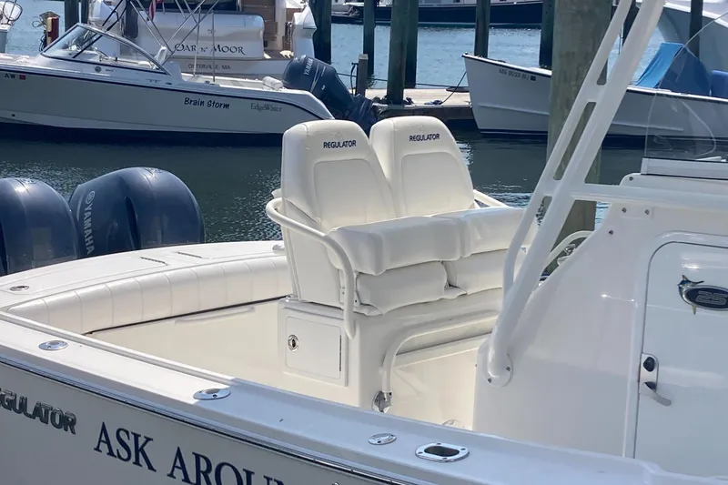 Slide: The Image of 2015 Regulator 25FS Center Console boat docked with Yamaha engines. - 30