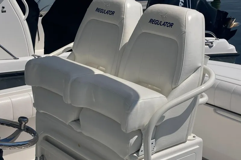 Slide: The Image of White leather seats on a 2015 Regulator 25FS Center Console boat. - 31