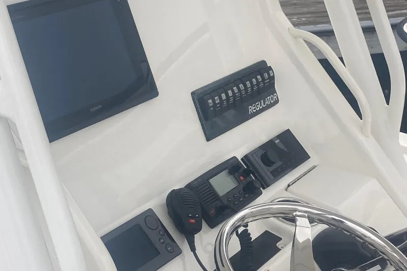 Slide: The Image of 2015 Regulator 25FS Center Console dashboard with navigation and communication equipment. - 36