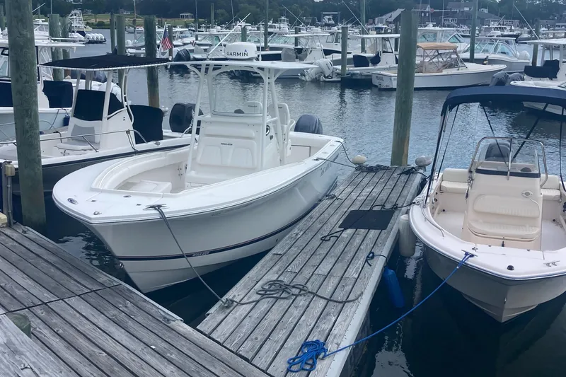 Slide: The Image of 2015 Regulator 25FS Center Console boat docked at a marina. - 4