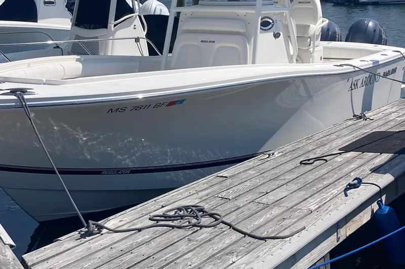 Slide: The Image of 2015 Regulator 25FS Center Console boat docked at a marina. - 5