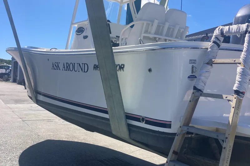 Slide: The Image of 2015 Regulator 25FS Center Console boat in dry dock, side view. - 6