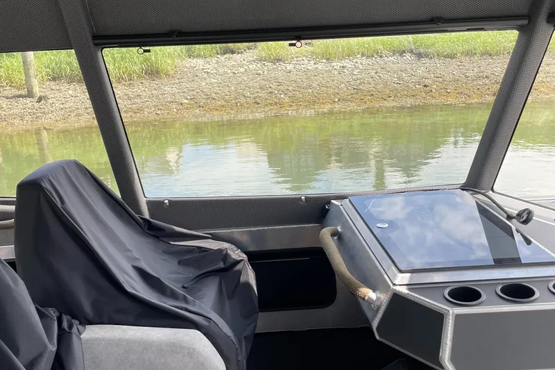 Slide: The Image of Interior of a 2024 Viggo C10 boat with covered seats and control panel. - 12