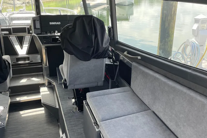 Slide: The Image of 2024 Viggo C10 boat interior with gray seating and navigation equipment. - 18