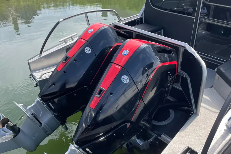 Slide: The Image of Twin outboard motors on a 2024 Viggo C10 boat, featuring sleek black and red design. - 3
