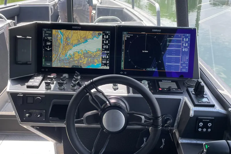 Slide: The Image of 2024 Viggo C10 boat dashboard with dual Simrad navigation screens and steering wheel. - 9